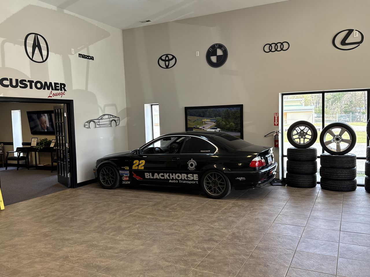 Blackhorse race car in the showroom with display wheels
